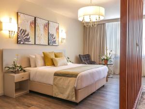 a bedroom with a large bed and a chandelier at Yaya Hotel & Apartments in Nairobi +94 photos