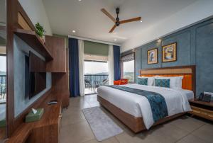 a bedroom with a large bed and a television at Hill Seasons Resorts and SPA in Tindummal +46 photos