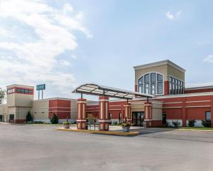 a large red building with a canopy in a parking lot at Quality Inn & Suites Mattoon South in Mattoon