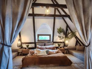 a person laying on a bed in a room at Nooks by AdyBeca - Panoramic Nook in Şuncuiuş