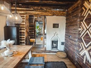 a living room with a table and a fireplace at Nooks by AdyBeca - Panoramic Nook in Şuncuiuş +24 photos
