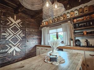 a kitchen with a table with a vase on it at Nooks by AdyBeca - Panoramic Nook in Şuncuiuş