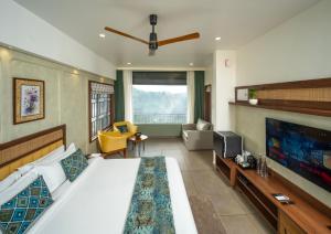 a bedroom with a large bed and a living room at Hill Seasons Resorts and SPA in Tindummal