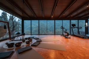 a room with a gym with a lot of windows at ZOLAND Resort Hotel ·Emei Mountain in Emeishan City