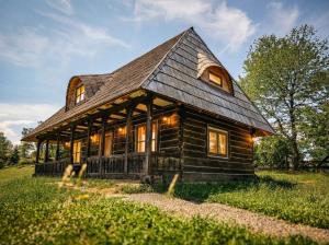 a log cabin with a gambrel roof at Nooks by AdyBeca - Panoramic Nook in Şuncuiuş
