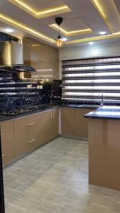 a large kitchen with black granite counter tops at Q2Shortlet Apartment in Isheri-Olofin