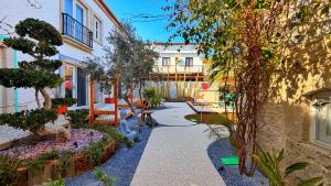 a courtyard of a building with trees and plants at Jardin d'Azur Alaçatı in Alaçatı
