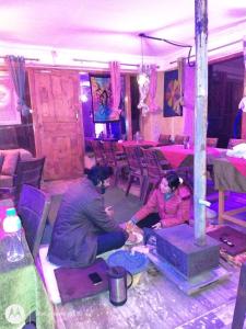 a couple of people sitting in a room at Shiva Valley Riverside in Jibhi
