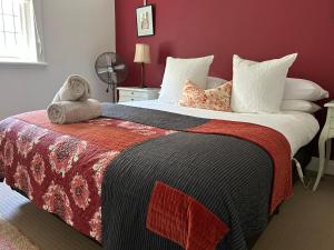 a bedroom with a large bed with a teddy bear on it at Lurline Villas in Katoomba