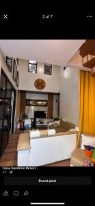 a living room with a white couch and a couch post at Casa Sandrine resort in Malolos