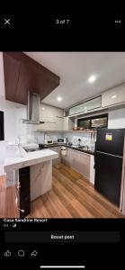 a kitchen with a black refrigerator and a white counter top at Casa Sandrine resort in Malolos