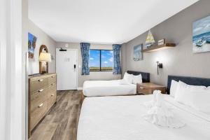 a hotel room with two beds and a window at Compass Cove 1466 in Myrtle Beach