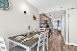 a dining room and kitchen with a table and chairs at Compass Cove 1466 in Myrtle Beach +28 photos