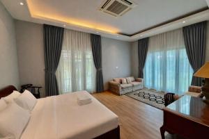 a bedroom with a bed and a living room at Villa Alam Klang managed by Bella Vista Hotels & Resorts in Klang