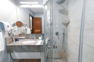 a bathroom with a shower and a sink at ARMİS HOTEL in İzmir +68 photos