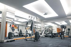 a gym with a lot of treadmills and machines at ARMİS HOTEL in İzmir