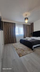 a bedroom with a bed and a chandelier at Apartament EVA in Suceava