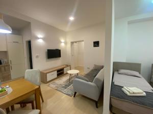 a living room with a bed and a dining room at BASC Modern 2 in Sarajevo
