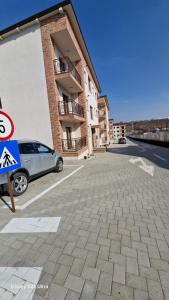 a car parked in a parking lot next to a building at Apartament EVA in Suceava