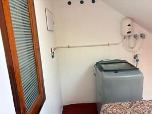 a small room with a washing machine in a room at Temple House in Trivandrum +60 photos