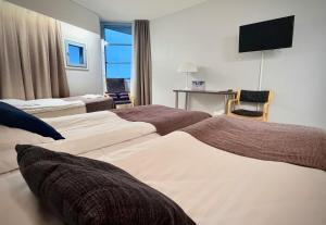 Llit o llits en una habitació de Hotelli Kivitippu