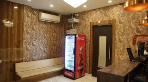 a room with a coca cola machine in a room at Tokyo Inn in Howrah