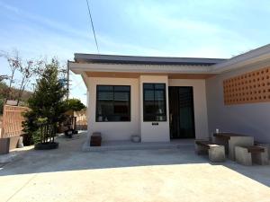 a small house with a lot of windows at Third Space House in Ban Chak Phak Kut +2 photos