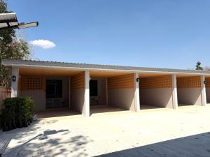 a large white building with a roof at Third Space House in Ban Chak Phak Kut