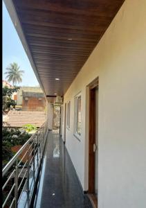 a hallway of a house with a wooden ceiling at Pallaki Residency in Hubli