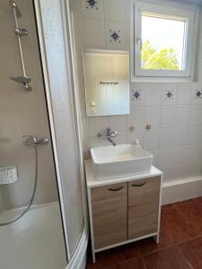 a bathroom with a sink and a shower at Beach House Mrzeżyno in Mrzeżyno
