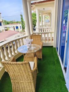 a patio with a table and chairs on a balcony at MoDi's Seaside Nest in Mombasa