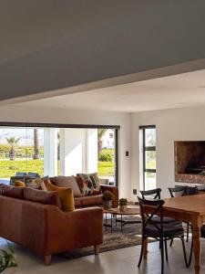 a living room with a couch and a table at Grace Eleven in Stompneusbaai