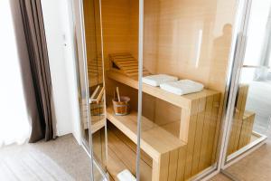 a walk in shower with wooden shelves and a glass door at Dilman Luxury Stay in Bari +77 photos