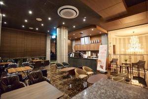 a restaurant with tables and chairs and a chandelier at Hotel The Star in Yeonggwang