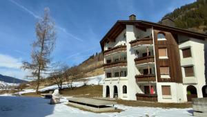 a large building with snow in front of it at Cadras 14 in Tinzen