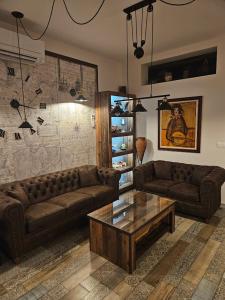 a living room with two couches and a coffee table at Флора Поморие in Pomorie