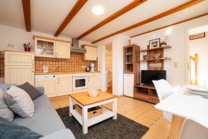 a living room with a couch and a table at Alte Scheune Koserow bei Baltic Home in Koserow