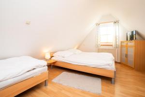 a bedroom with two beds and a window at Alte Scheune Koserow bei Baltic Home in Koserow +32 photos
