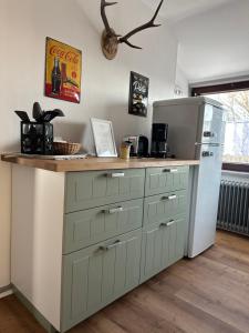a kitchen with a counter and a refrigerator at GP Ferienwohnung in Goslar