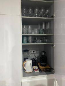 a cupboard filled with lots of glasses and a blender at Center Luxury Chalet Mazagón in Mazagón