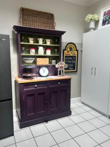 a cabinet with a clock on it in a kitchen at Lurline Villas in Katoomba