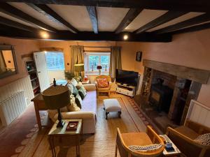 a living room with a couch and a fireplace at Maengwynedd, Llanrhaeadr Ym Mochnant in Oswestry +21 photos