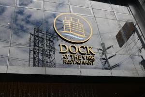 a sign on a building that says dog at the use restaurant at Vibe Hotel Alabang in Manila
