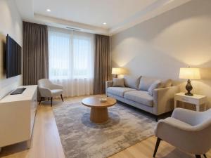 a living room with a couch and a table at Hotel Grand Loft Near IGI Airport New Delhi in Pilwa