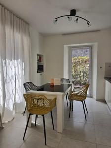 a dining room with a table and chairs and a window at Casa Chiara in Cavergno +9 photos