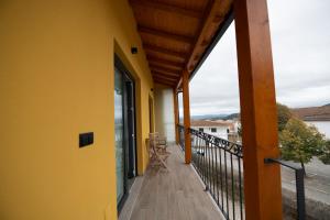 a balcony of a house with a yellow wall at Casa Avó Libânia in Murça