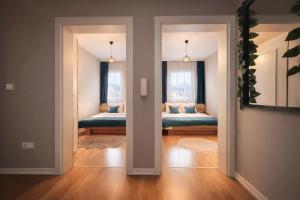 a room with two beds and two windows at Siera's Penthouse in Prishtinë