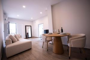 a living room with a table and chairs and a couch at Casa Avó Libânia in Murça
