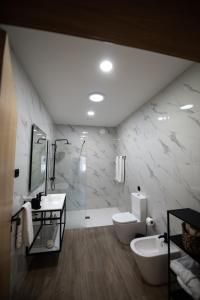 a bathroom with two sinks and a shower and a tub at Casa Avó Libânia in Murça +2 photos