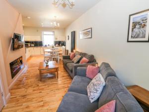 a living room with a couch and a table at Corner Cottage in Buxton